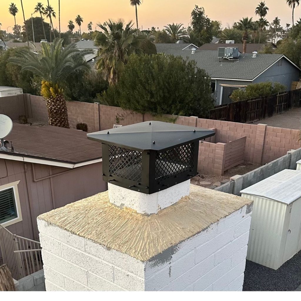 Chimney with new crown seal and black protective cap at sunset