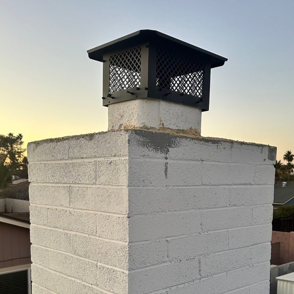 New chimney cap installation on repaired brick chimney by EcoAirClean.