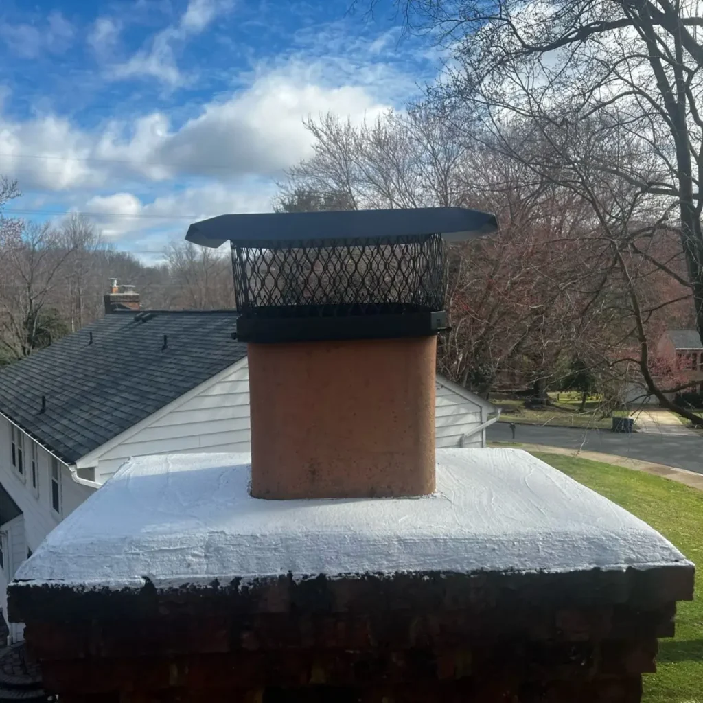 Chimney with new crown seal and protective chimney cap installed.
